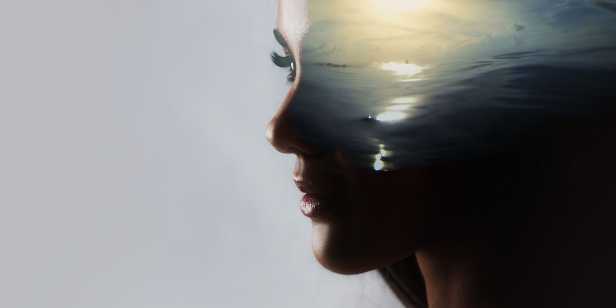 Woman's face merging into sea