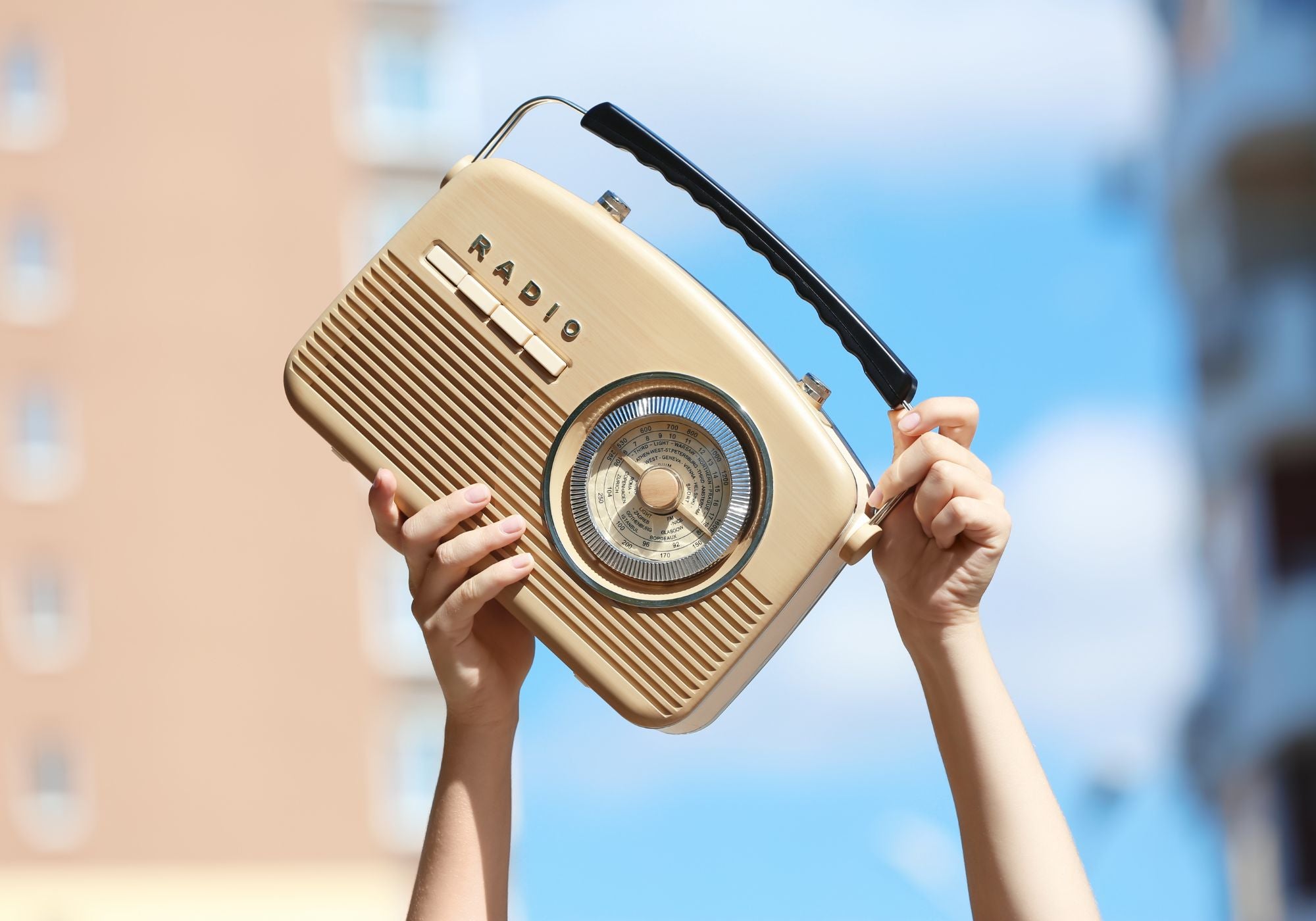 antique radio being lifted by a woman