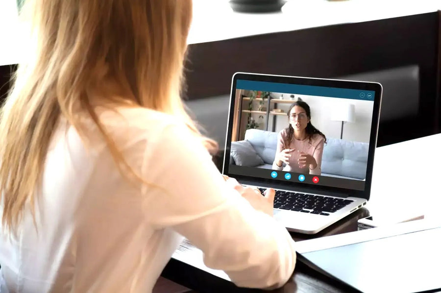 Woman talking on laptop
